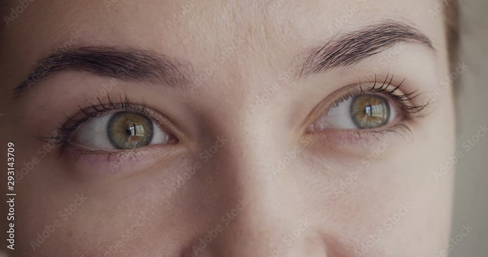 Close-up view on woman blinks and looks away.