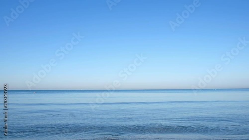 Sea surface with light waves and clear horizon