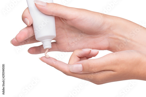 The foundation is poured on the finger, women's hands are holding a tube