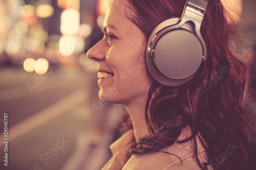 Smiling girl with headphones in NYC