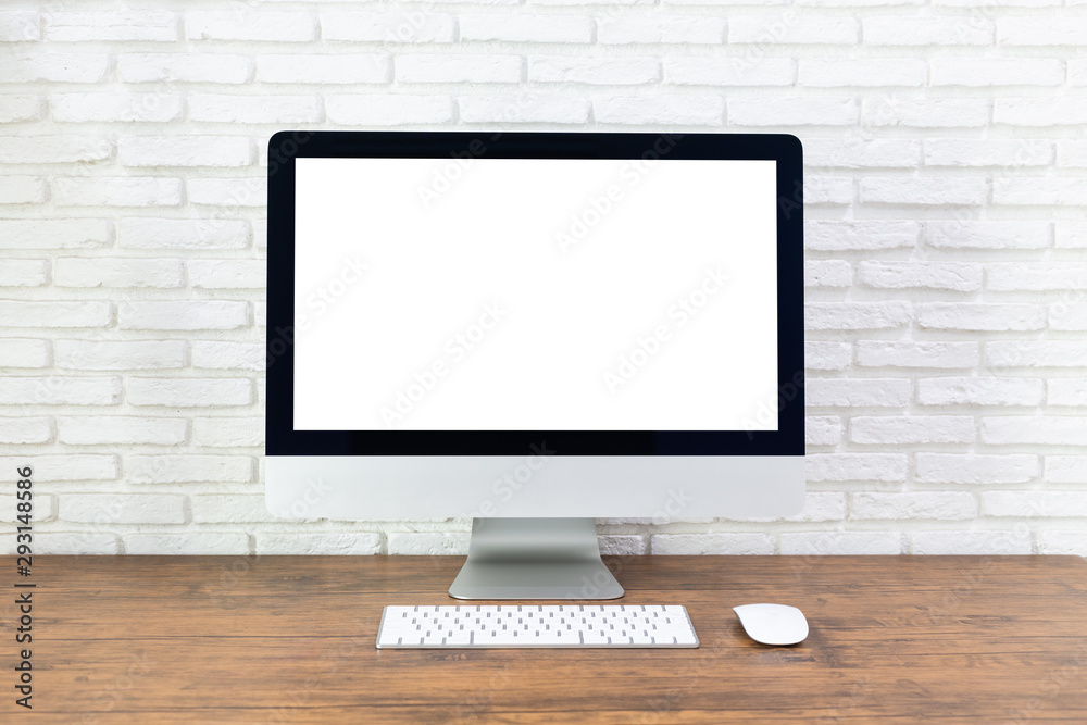 computer with blank white screen, with workspace and office supplies on a wooden desk computer with blank white screen, with workspace and office supplies on a wooden desk