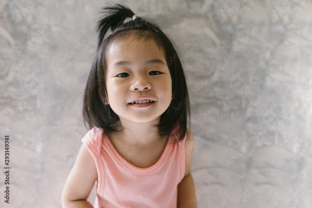Close-Up Portrait Of Cute Girl Standing Against Wall Close-Up Portrait Of Cute Girl Standing Against Wall