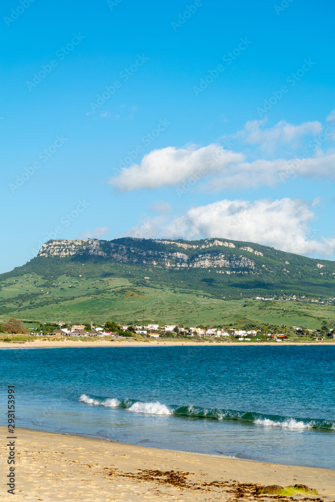 a view of one of the mountain peaks and skys seen from Bolonia beach in Cadiz, spain 