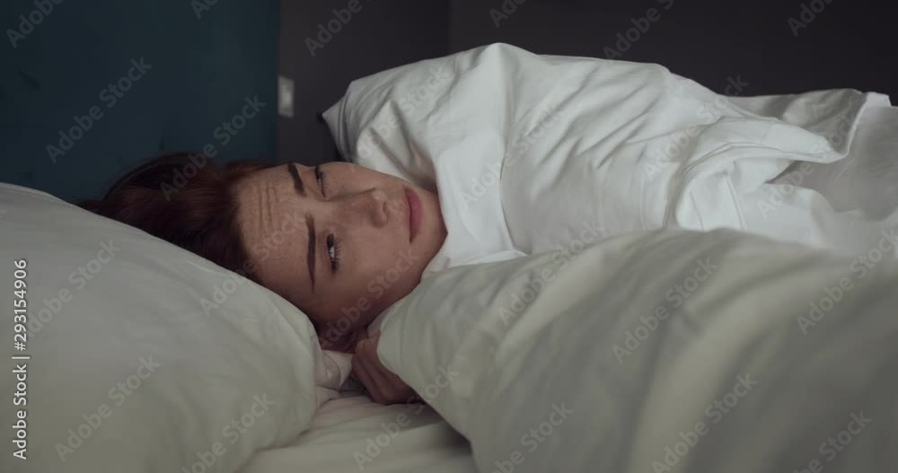 Beautiful redhead woman awakening without mood in cozy bed. Beautiful redhead woman awakening without mood in cozy bed.