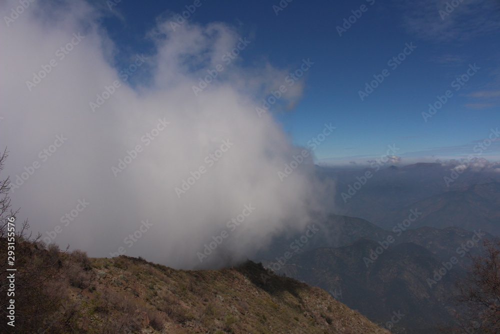 a big cloud covering a mountain