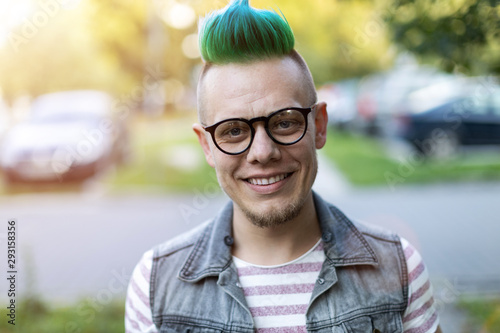 Portrait of a cool young man with pink mohawk photo