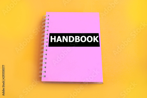 Pink handbook with yellow background photo