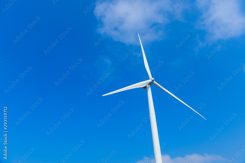 Windmill farm in the wind park , windmills isolated at sea on a beautiful bright day Windmill farm in the wind park , windmills isolated at sea on a beautiful bright day