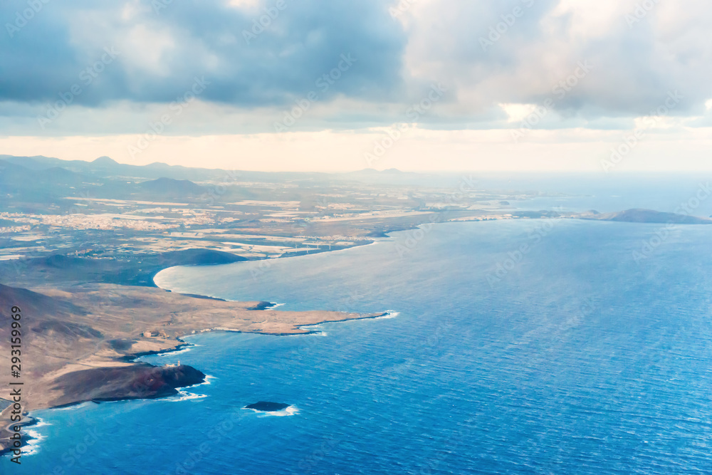 Obraz premium Airplane aerial view of coastal landscape and town of Arinaga on Gran Canaria island with ocean, hills and cities