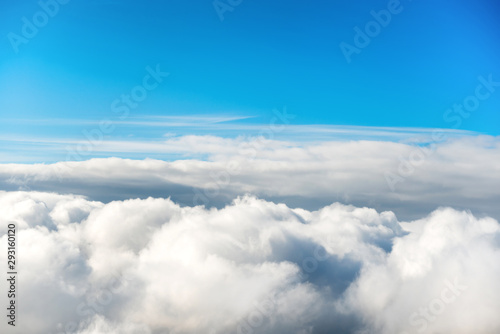Cloudscape with clear blue sky and fluffy clouds, view from above © Pavlo Vakhrushev