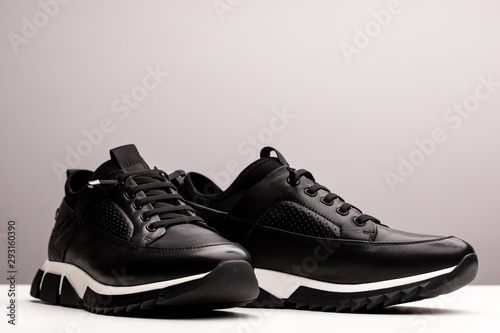 Pair of new unbranded black sport running shoes, sneakers or trainers isolated on white background 