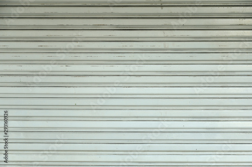 An old light gray rolling steel door texture