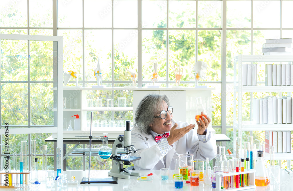 Senior male supervisor doing experiments and researchers working in the laboratory. Senior male supervisor doing experiments and researchers working in the laboratory.