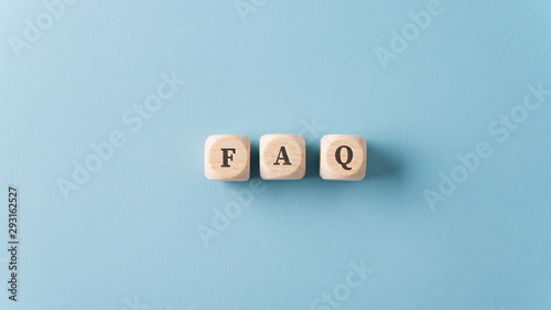 FAQ sign over light blue background photo