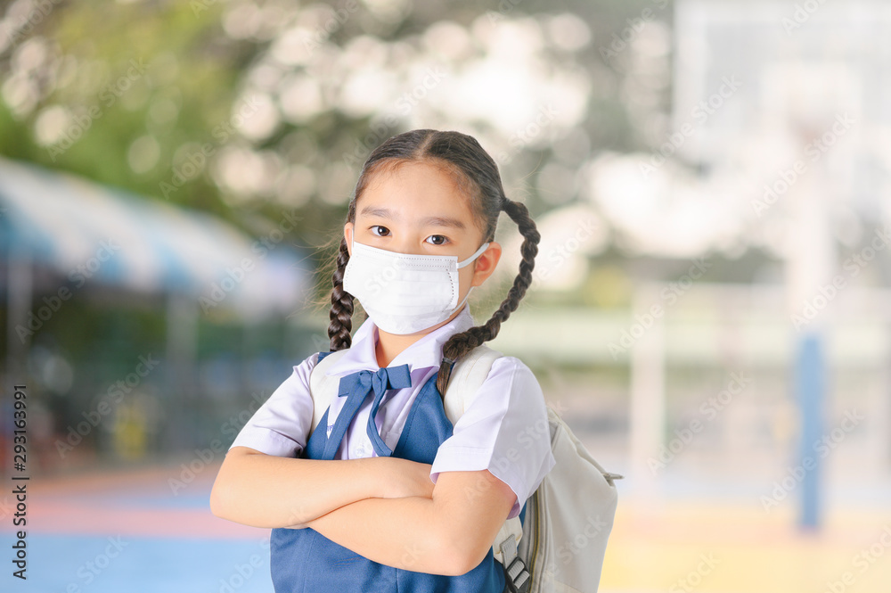 School Girl wearing mouth mask against air smog pollution in Bangkok city, Thailand School Girl wearing mouth mask against air smog pollution in Bangkok city, Thailand