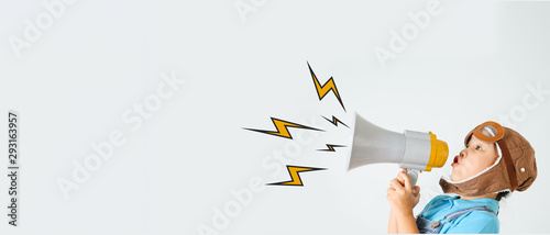 Cute funny girl with megaphone on color background. Space for text
