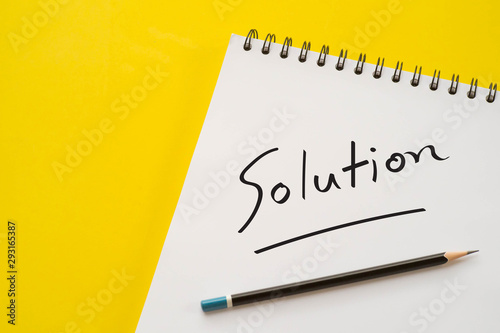 Notebook and pencil with Solution word