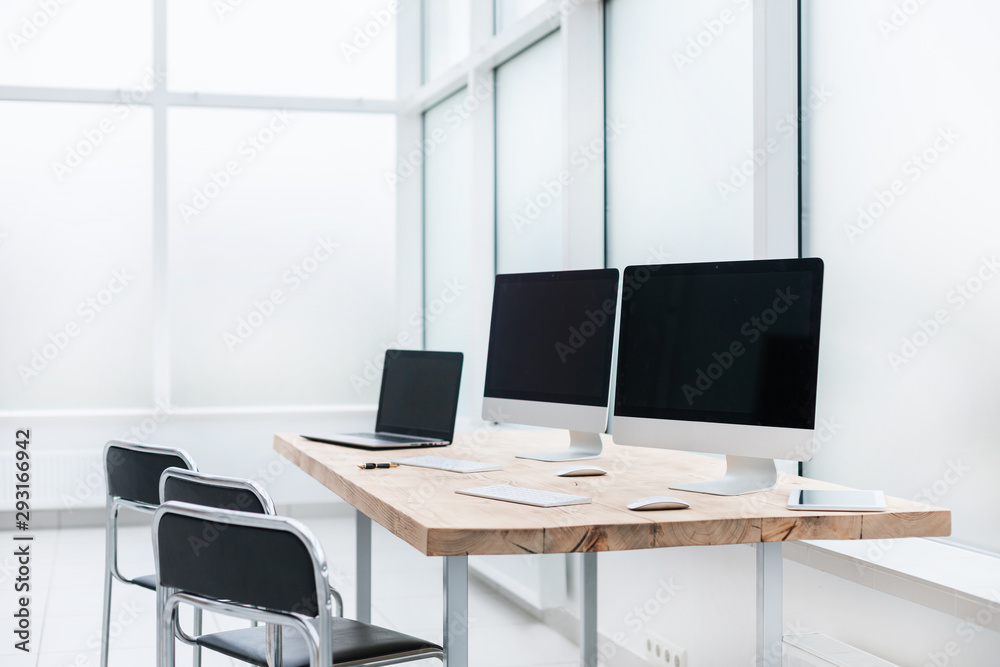 workplace with computers on the table in an empty office. workplace with computers on the table in an empty office.