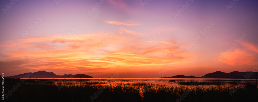 panoramic view of sunset above the lake with twilight sky