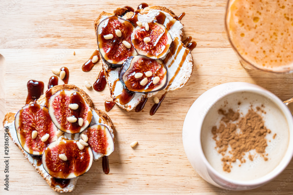 Breakfast Concepts, Toasts with Cream Cheese, Figs, Pine Nuts and Raspberry Balsamic Sauce, Cup of Cappuccino and Carrot-Apple Juice Breakfast Concepts, Toasts with Cream Cheese, Figs, Pine Nuts and Raspberry Balsamic Sauce, Cup of Cappuccino and Carrot-Apple Juice