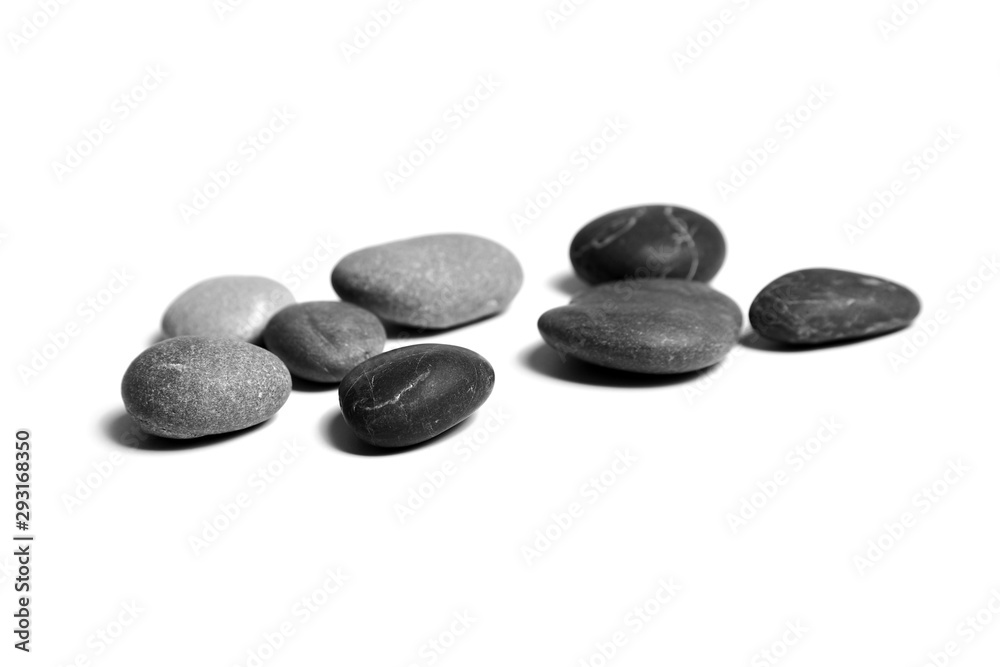 Sea pebbles. Heap of smooth gray and black stones isolated on white background
