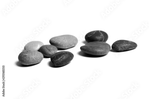 Sea pebbles. Heap of smooth gray and black stones isolated on white background