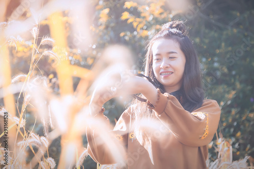 Portrait of beautiful asian girl are taking photo by campact camera in the garden with sunrise. photo