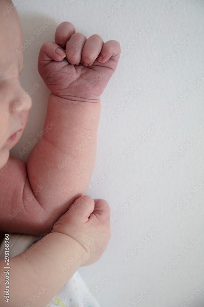 Close up of a cute sleeping baby resting on their arms Close up of a cute sleeping baby resting on their arms