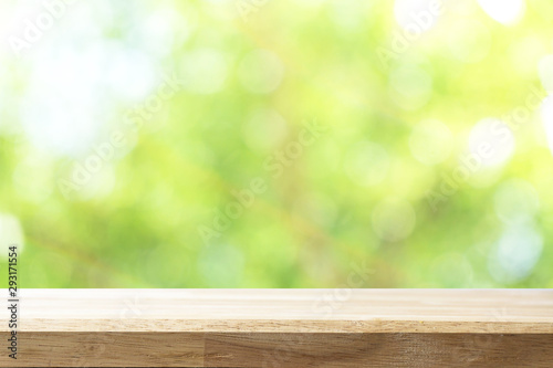 Empty white table and blurred garden bokeh background. mock up for display or montage of product, Business presentation.