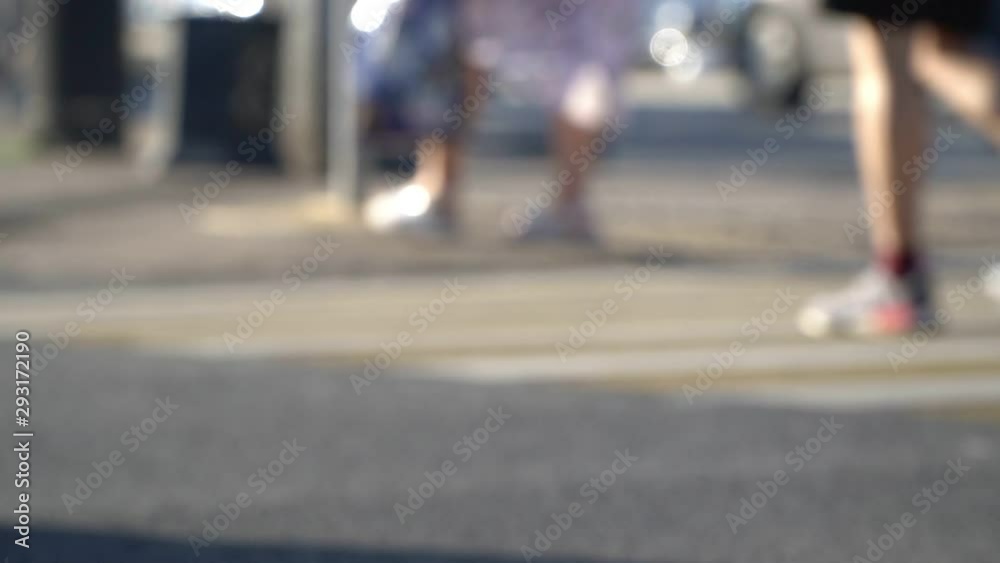 blurry pedestrians move across street at bright day light blurry pedestrians move across street at bright day light