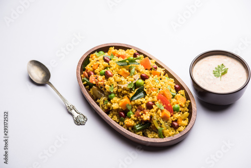 Broken wheat or Daliya Upma, served in a bowl. selective focus