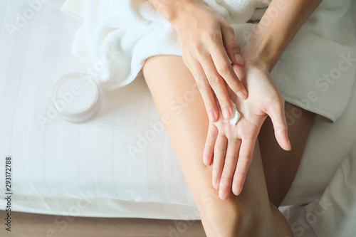 Woman applying moisturizing cream/lotion on hands, beauty concept.