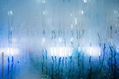 Drops of rain on window with.background abstract bokeh lights. copy space background for text