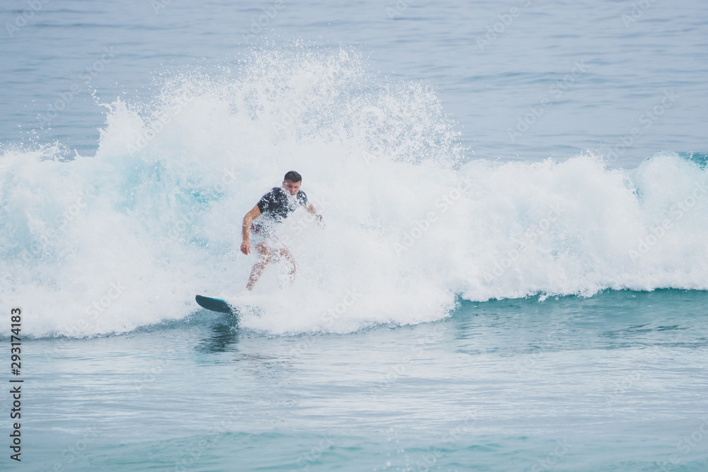 Male surfer in a breaking wave. Short board. Atlantic Ocean. Male surfer in a breaking wave. Short board. Atlantic Ocean.