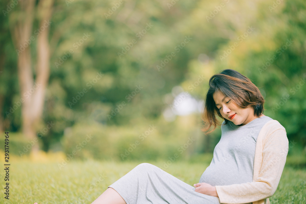 Happy pregnant woman relaxing outside in the park outdoor Happy pregnant woman relaxing outside in the park outdoor