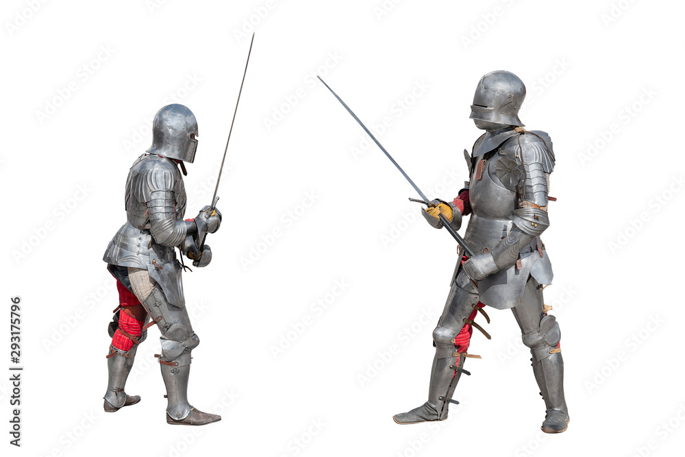Knights in armor. Medieval knights in iron armor hold swords in their hands. Duel of the medieval warriors. The battle of two knights on swords. Knights in armor. Medieval knights in iron armor hold swords in their hands. Duel of the medieval warriors. The battle of two knights on swords.
