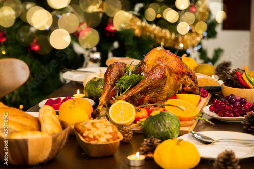 Fototapeta Naklejka Na Ścianę i Meble -  Roasted  chicken or turkey with sauce and grilled autumn vegetables: corn,pumpkin  on wooden table, top view, frame. Christmas or Thanksgiving Day food concept.