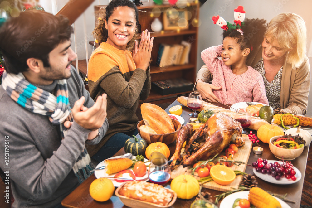 Thanksgiving Celebration Tradition Family Dinner Concept.family having holiday dinner and cutting turkey.Young black adult woman and her daughter happy..