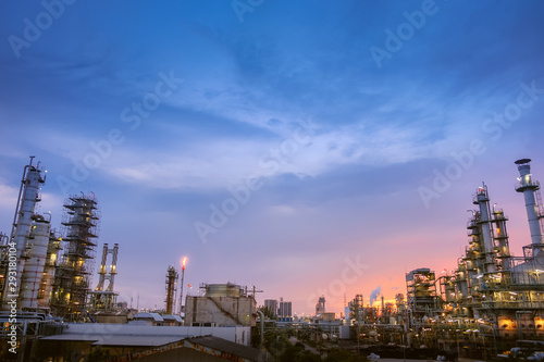 Oil and gas refinery plant or petrochemical industry on blue sky sunset background, Manufacturing of petroleum plant with distillation tower and smoke stacks