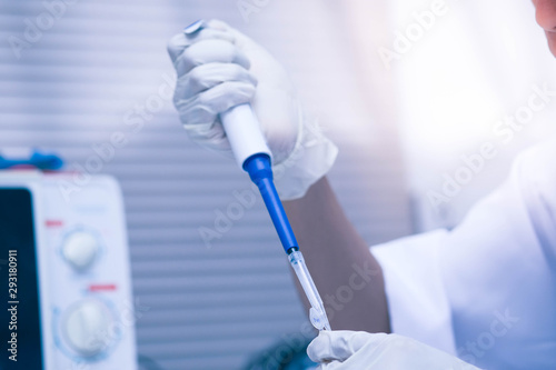 scientist using auto-pipette with Eppendorf consumables tube in the lab,Doing experiment for product,The researchers analyzed to find the results of the experiment.
