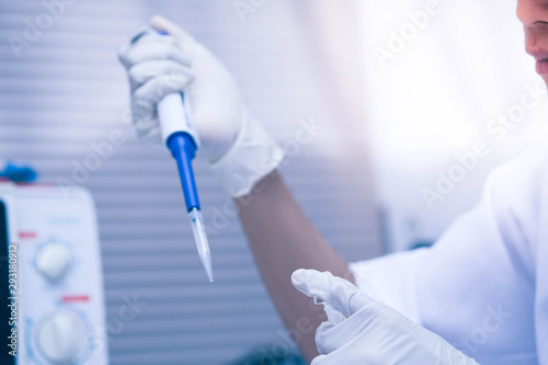 scientist using auto-pipette with Eppendorf consumables tube in the lab,Doing experiment for product,The researchers analyzed to find the results of the experiment.