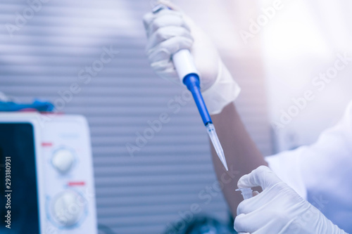 scientist using auto-pipette with Eppendorf consumables tube in the lab Doing experiment for product The researchers analyzed to find the results of the experiment.