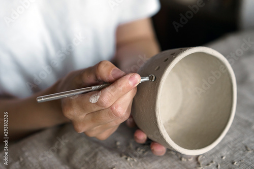 Female hands hold a bowl for casting clay products. Shaped method for making clay dishes. Handwork. Pottery making
