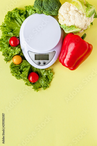 Fresh vegetables on vase on yellow background. Healthy eating, diet planning, weight loss, detox, organic farming concept