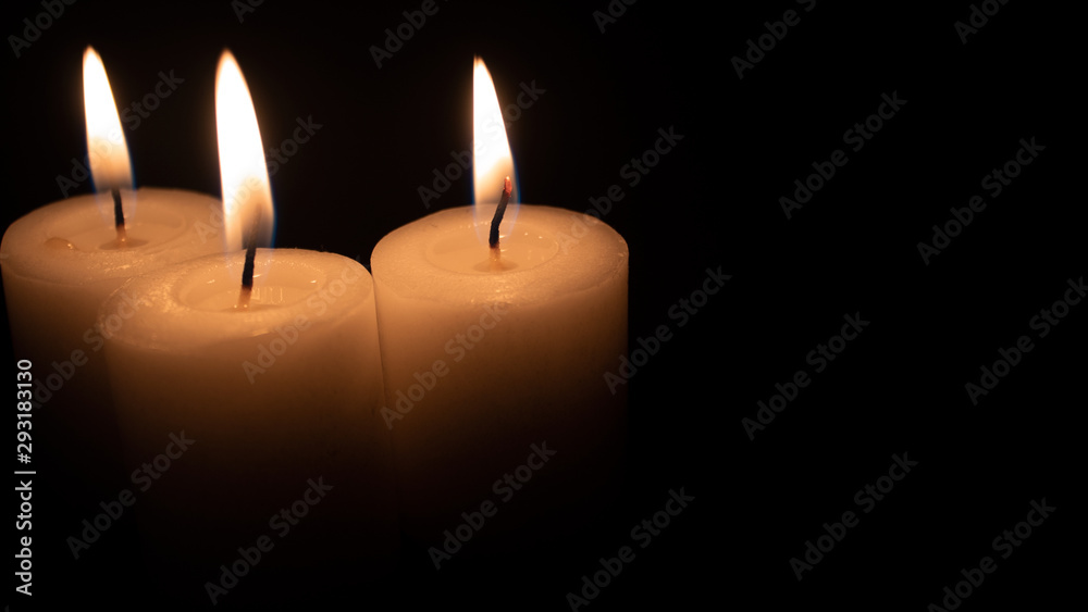 Burning candles on a black background with space to put any text Burning candles on a black background with space to put any text