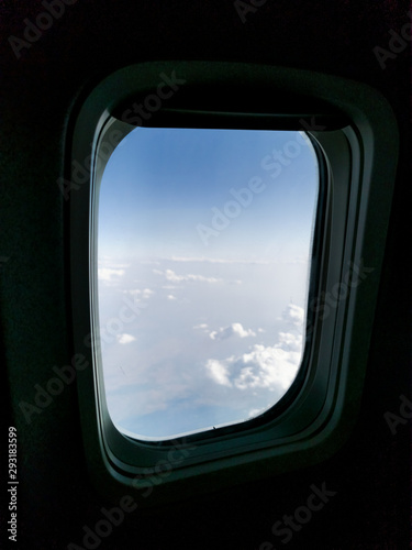 airplane window cloudscape view from above the clouds