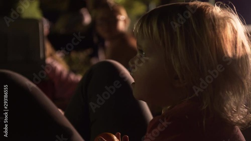Child watches fireworks in a park