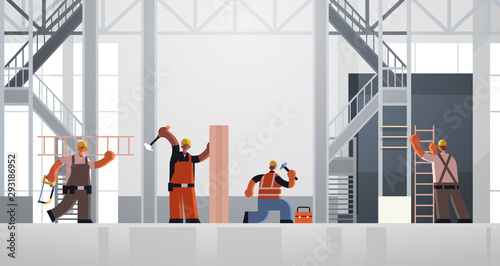 builders using hammer and ladder busy workmen carpenters team in uniform working together building concept construction site interior flat full length horizontal