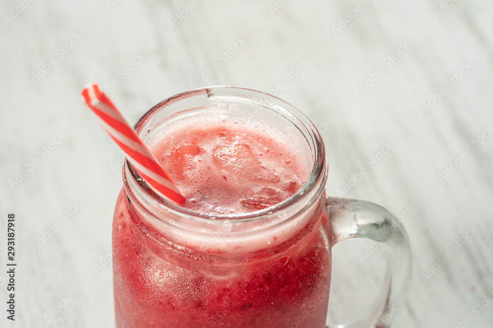 Fresh organic red smoothie in glass mug on white table, close up. Refreshing summer fruit drink. The concept of healthy eating. Cranberry and raspberry smoothie Fresh organic red smoothie in glass mug on white table, close up. Refreshing summer fruit drink. The concept of healthy eating. Cranberry and raspberry smoothie