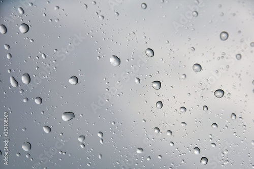Rain drops with selective focus on transparent glass. Glass surface with water drops. Window with raindrops. water drops on glass. Rainy autumn weather